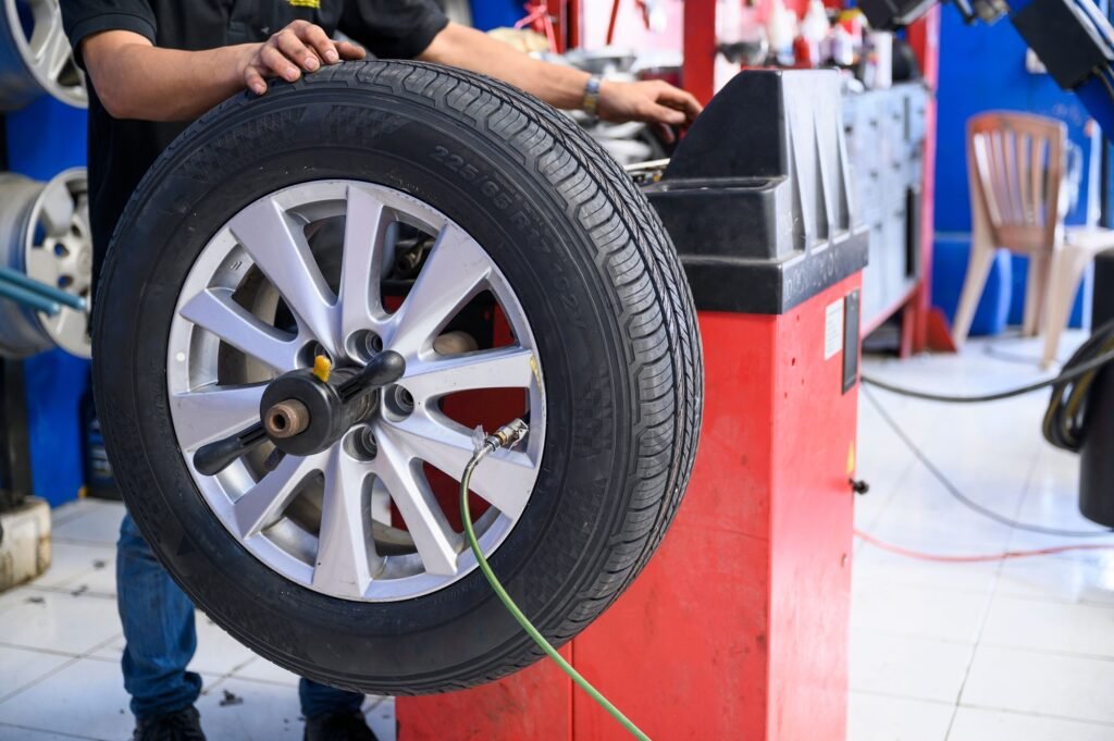 Mechanic replacing a tire on rim by machine